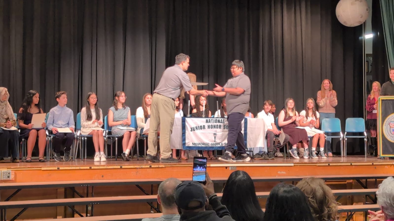 Receiving the NJHS certificate on stage